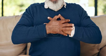 Photo for Hands, senior man and heart attack with pain, cardiovascular healthcare and risk of hypertension at home. Closeup, elderly injury and heartburn in chest, indigestion and medical emergency for stroke. - Royalty Free Image