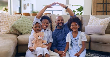 Photo for Black family, roof hands or portrait of happy kids in living room at home for support or insurance. Security, property investment or parents with children siblings for cover, safety or protection. - Royalty Free Image
