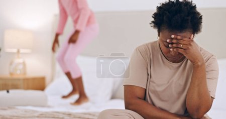 Photo for Frustrated mother, headache and child jumping on bed in stress, anxiety or mental health at home. Tired African mom in depression, mistake or burnout with ADHD kid playing in bedroom chaos at house. - Royalty Free Image