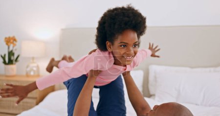 Photo for Bedroom, airplane and happy black family, child and dad playing, having fun and enjoy flying game at home. Bed, love and African papa support, bond or lift kid, girl or daughter imagine plane flight. - Royalty Free Image