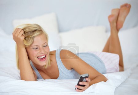 Photo for Happy, relax and woman on a phone on bed networking on social media, mobile app or the internet. Smile, rest and young female person from Australia scroll on cellphone in bedroom at modern apartment - Royalty Free Image