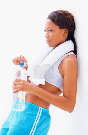 Photo for Black woman, fitness and water with thinking and bottle from sport, workout and training in studio. Leaning, healthy and African female athlete with wellness and drink after gym with white background. - Royalty Free Image