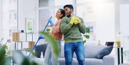 Photo for Happy couple, dancing and singing while cleaning living room together for fun disinfection or hygiene at home. Man and woman enjoying housekeeping, germ and bacteria removal in lounge at house. - Royalty Free Image