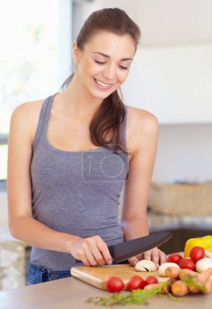 Photo for Woman, thinking and smile with knife or vegetables for nutrition, cooking or healthy meal in kitchen of home. Person, face and chopping board with mushroom, tomato and carrots for wellness and diet. - Royalty Free Image