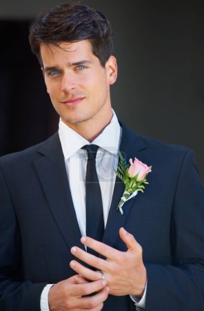 Photo for Groom man, portrait and wedding in suit, rose or flower for celebration, event or party with ring. Person, hands and face with choice, marriage and commitment to relationship with floral decoration. - Royalty Free Image
