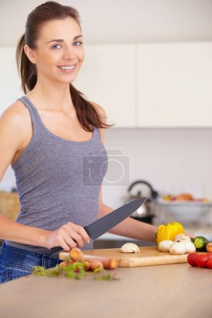Photo for Woman, portrait and smile with knife or vegetables for nutrition, cooking or healthy meal in kitchen of home. Person, face and chopping board with mushroom, peppers and carrots for wellness and diet. - Royalty Free Image