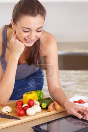 Photo for Woman, tablet and smile with vegetables in kitchen for nutrition, cooking recipe or healthy meal in home. Person, face and chopping board with mushroom, peppers and carrots for wellness and diet. - Royalty Free Image