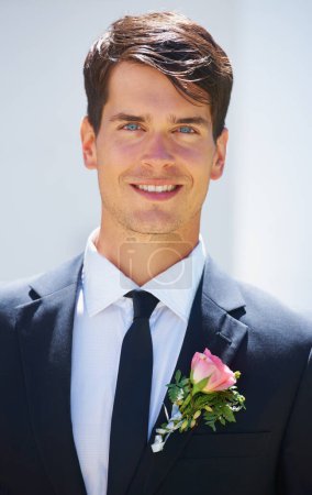 Photo for Groom man, portrait and outdoor at wedding in suit, rose and happy for celebration, event or party. Person, smile and tuxedo for choice, marriage and commitment to relationship with floral decoration. - Royalty Free Image