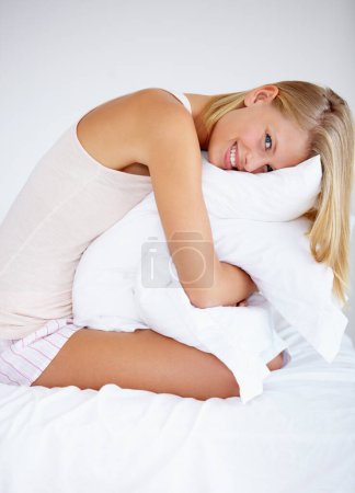 Photo for Person, portrait or hugging bedroom pillow in house for relax, break or weekend rest. Smile, happy or morning woman in pajamas embracing hospitality bedding in hotel, home and comfortable apartment. - Royalty Free Image