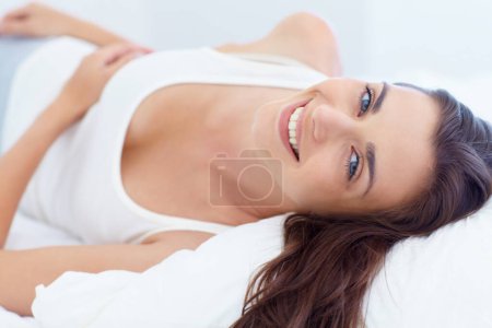 Photo for Smile, bed and wake up, portrait of woman in morning and natural wellness in home on summer weekend. Relax, healthy rest and peace, happy face of girl in bedroom of apartment, hotel room or house. - Royalty Free Image