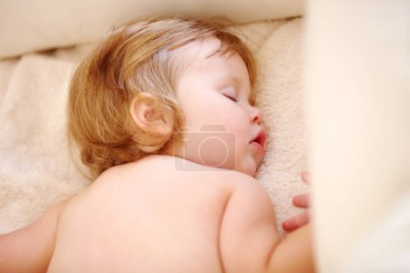 Photo for Closeup, baby and face for sleep on bed from good dream, nap or rest in nursery. Toddler, relaxing or peaceful on pillow, blanket or cozy for child growth, tired or development for future in home. - Royalty Free Image
