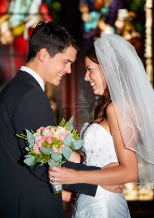 Photo for Happy couple, wedding and love at church for commitment, marriage or affection together at ceremony. Married man and woman smile in joy with bouquet of roses or flowers for romantic relationship. - Royalty Free Image