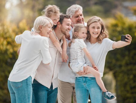 Photo for Selfie of big family in garden together with smile, grandparents and parents with kids in backyard. Photography, happiness and men, women and children in park with love, support and outdoor bonding - Royalty Free Image