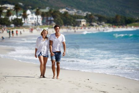 Photo for Couple, holding hands and smile on walk by sea, vacation or freedom in summer sunshine for bonding. Man, woman and happy in portrait, care or love by sand, waves or outdoor on beach holiday in Napoli. - Royalty Free Image