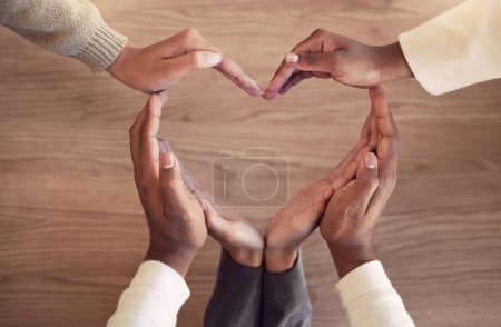 Photo for Business, collaboration and heart hands on a wooden background from above for love in the office. Team building, health and wellness with an employee group in the workplace together for unity. - Royalty Free Image