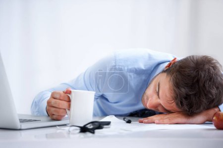Photo for Business man, sleeping and tired at work, burnout and exhausted or mental health, desk and overwhelmed. Male person, dreaming and lazy in office, resting and fatigue or low energy, coffee and nap. - Royalty Free Image