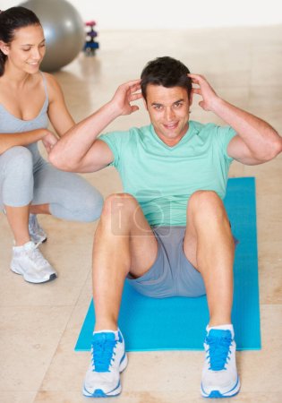 Photo for Personal trainer, fitness and portrait of man sit up in exercise and workout for health, wellness and cardio, People, training or coach helping person with core, crunches and pilates routine in gym. - Royalty Free Image