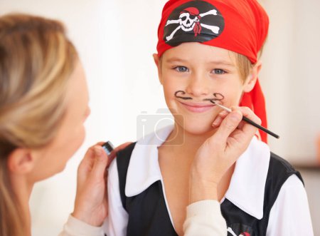 Photo for Boy, portrait or pirate face paint with woman, halloween or holiday happiness in childhood in home. Child, mother and theme make up for vacation, clothes and love care for party celebration in house. - Royalty Free Image