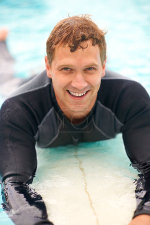 Photo for Portrait, man and surfer in ocean with board, health fitness and happy in summer with water sports. Person, smile and face of relax wellness in caribbean with vacation, adventure and workout on beach. - Royalty Free Image