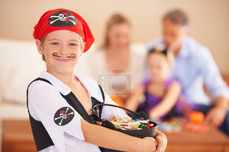 Photo for Boy, portrait or candy for halloween in home, face paint or happiness in childhood. Son, chocolates and family on holiday for trick o treat, pirate costume and love in celebration together in house. - Royalty Free Image