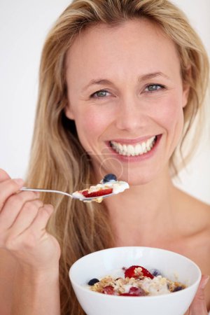 Photo for Happy woman, portrait and muesli bowl for diet, nutrition or health and wellness against a studio background. Female person, blonde or model smile with healthy cereal or natural food for breakfast. - Royalty Free Image