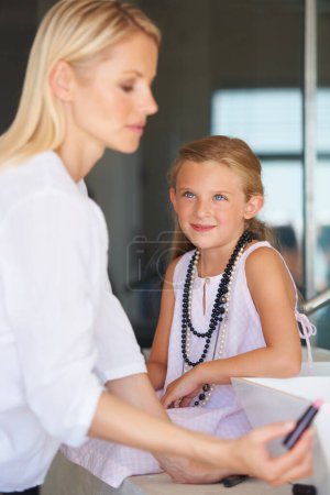 Photo for Mother, child and smile for beauty, makeup and support in bathroom, lipstick and fun at home. Mom, daughter and learning or play, cosmetics and skincare or bonding, love and teaching or grooming. - Royalty Free Image