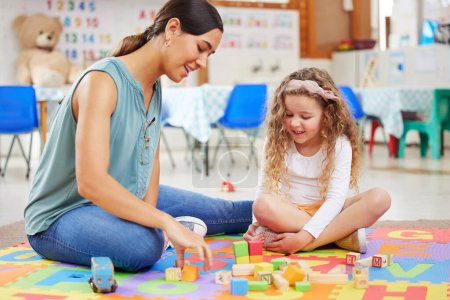 Photo for Woman, kid and toys for playing in classroom for learning, fun or development. Female teacher, little girl and colorful blocks for education, growth or milestone in childhood with exciting activity. - Royalty Free Image