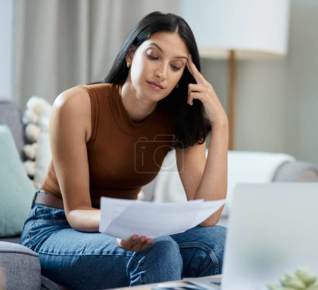 Photo for Frustrated woman, documents and headache for debt, stress or mistake in burnout on living room sofa at home. Female person with paperwork or migraine in anxiety for financial crisis or bills at house. - Royalty Free Image