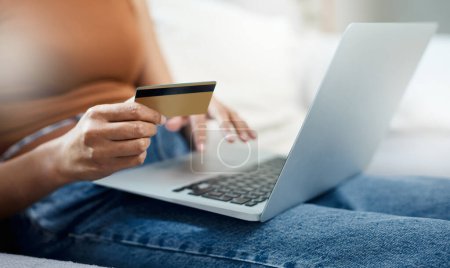 Photo for Laptop, credit card and hands for home online shopping, e commerce and digital payment or order on sofa. Relax person typing on computer for internet banking, subscription or registration for a loan. - Royalty Free Image
