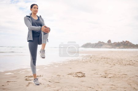 Photo for Fitness, warm up and woman athlete on the beach for health and race, marathon or competition training. Sports, workout and young female runner stretching for cardio exercise by the ocean or sea - Royalty Free Image
