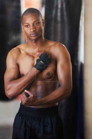 Photo for Boxing, gym and black man wrapping hands with fitness, power and training challenge. Strong body, muscle workout and boxer in gym, athlete with confidence and getting ready for fighting competition - Royalty Free Image