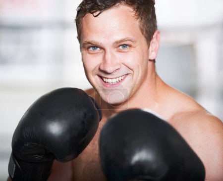Photo for Boxing, gloves and portrait of happy man with fitness, power and training for challenge in gym. Strong body, muscle and smile, boxer or athlete with fist up, face and confidence in competition fight - Royalty Free Image