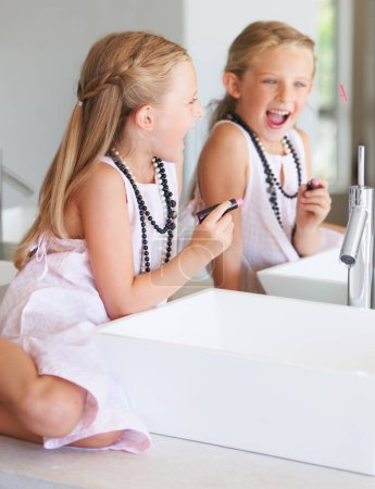 Photo for Kid, lipstick and smile for mirror in bathroom with mark, writing or drawing with bad behavior. Little girl, happy and laugh for picture, naughty and problem with mom, makeup or cosmetics for beauty. - Royalty Free Image