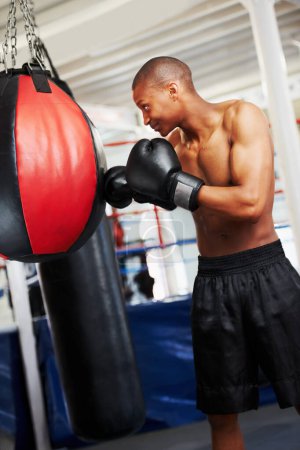 Photo for Black man, boxing and punching bag at gym for workout, exercise or self defense practice in fighting sport. African male person or boxer with gloves for indoor training or martial arts at health club. - Royalty Free Image