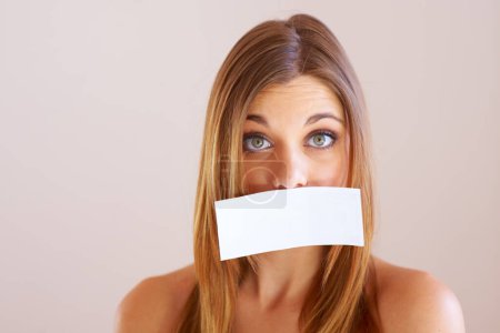Photo for Woman, mouth and sign for cover with mock up for silence in studio on white background. Portrait, female model and surprise in copy space for announcement, news or secret with placard, sign or poster. - Royalty Free Image