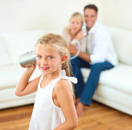 Photo for Portrait, tin can and girl with parents, home and happiness with fun, playing and bonding together. Face, kid and child with mother, father on a sofa and cheerful with joy, game and talking in lounge. - Royalty Free Image