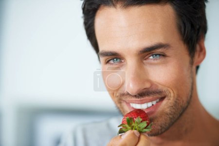 Photo for Home portrait, happy man and eating strawberry for morning diet, healthy lifestyle or fruit benefits, wellness or breakfast. Natural detox, nutrition food and face of person smile for antioxidants. - Royalty Free Image
