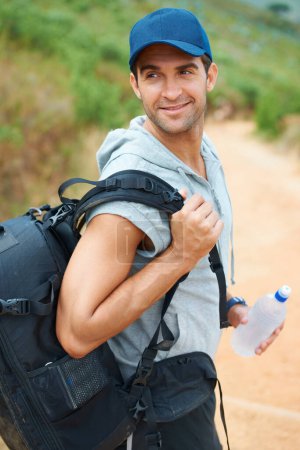 Photo for Water, hiking and smile with man in nature for health, trekking and summer adventure. Travel, explore and journey with person walking in mountain path for backpacking, relax and wellness vacation. - Royalty Free Image