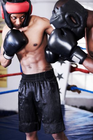 Photo for Boxing, man and sparring partner in ring together with headgear, gloves and fitness, power training, challenge. Strong body, fighting hit and boxer in helmet, fearless and confident in competition - Royalty Free Image
