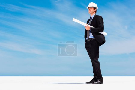 Photo for Engineer with helmet, blueprint and thinking with blue sky, mock up or project management. Architecture, construction space and business man with building planning, design idea and contractor on site. - Royalty Free Image