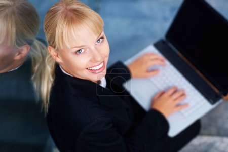 Photo for Portrait of happy woman on stairs in office with laptop, smile or relax in lobby for market research on web. Face of businesswoman on steps typing email, report or online business schedule from above. - Royalty Free Image