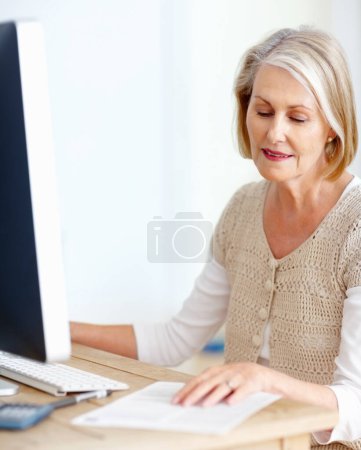 Photo for Mature woman at desk with computer, paperwork and administration for business accounting. Report, review and senior businesswoman reading invoice documents for finance, budget and office management. - Royalty Free Image