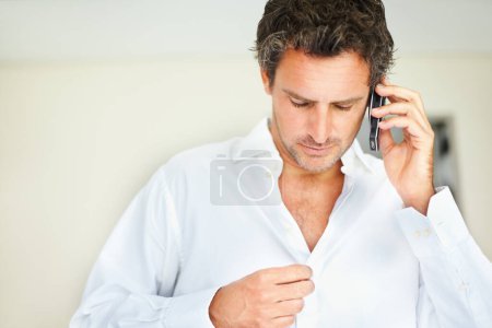 Photo for Phone call, shirt and business man in bedroom getting ready for work, job and career at home. Morning, communication and person dressing clothes button on cellphone for conversation, chat and contact. - Royalty Free Image