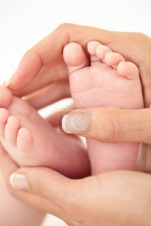 Photo for Woman, child and feet closeup for holding love or childhood bonding, motherhood or newborn. Female person, infant and toes or care support for kid growth development, parent trust or nurture youth. - Royalty Free Image