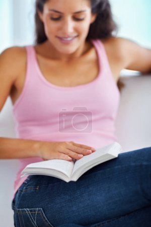 Photo for Home, relax and woman reading book, information or fantasy fiction story, autobiography or creative novel. Wellness, living room couch and student free time, hobby and check english literature. - Royalty Free Image