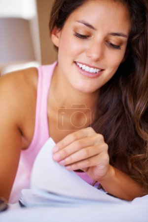 Photo for Young, woman and reading of book in bedroom for college, university or studying for test. Female, student and smile for learning, education and coursework with information, notes or paper for exam. - Royalty Free Image