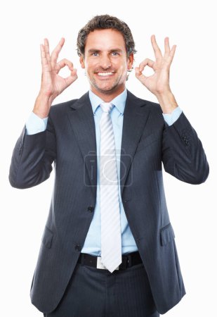 Photo for Businessman, ok and smile in portrait, promotion and agreement or approval by white background. Male person, face and emoji or icon, yes and like or success, satisfaction and good job or well done. - Royalty Free Image