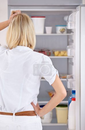 Photo for Woman, fridge and thinking for food meal decision or dinner eating, cooking thoughts for lunch snack. Female person, home appliance and wondering in kitchen groceries for hungry, storage for health. - Royalty Free Image