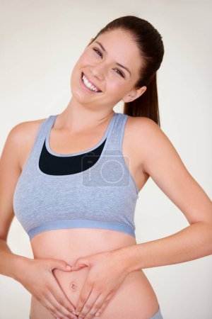 Photo for Heart, hands on stomach and portrait of woman for fitness, workout and exercise to lose weight. Happy, gut health and person with shape on tummy for wellness, digestion and diet for healthy body. - Royalty Free Image