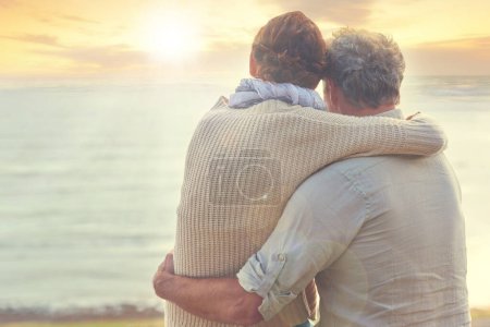 Photo for Old couple, hug and sunset on sea at the beach with care, support and trust in marriage or retirement. Back, man and woman in embrace with love, kindness and gratitude for vacation or holiday. - Royalty Free Image